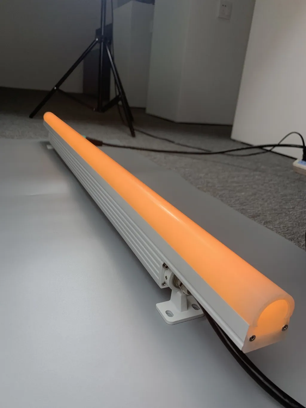 Long bar lit orange on the studio floor.