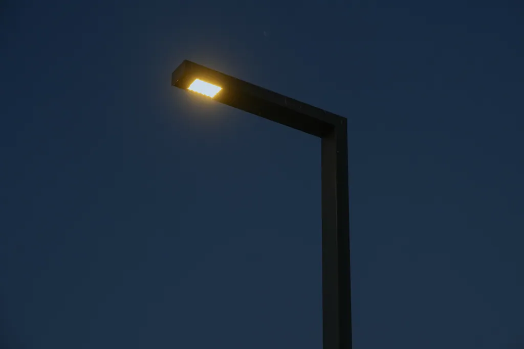 Single-arm urban pole lit against the night sky, Sylvan Golf & Country Club