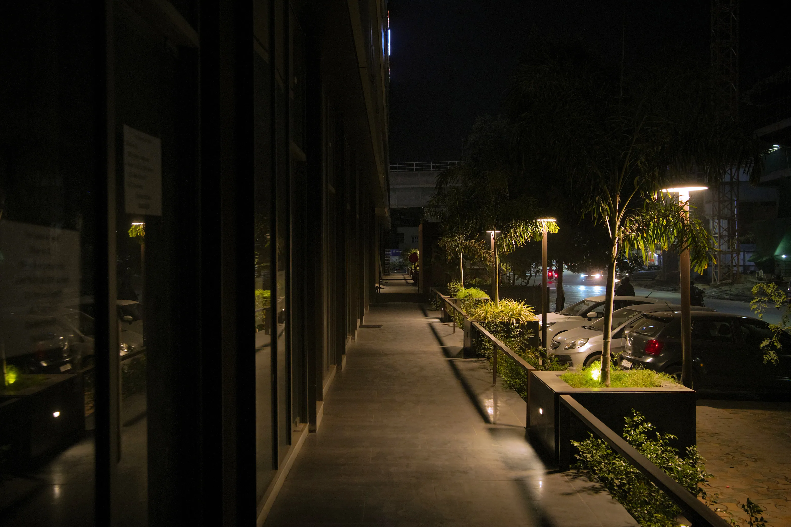The walkway between the glazing and the planters.