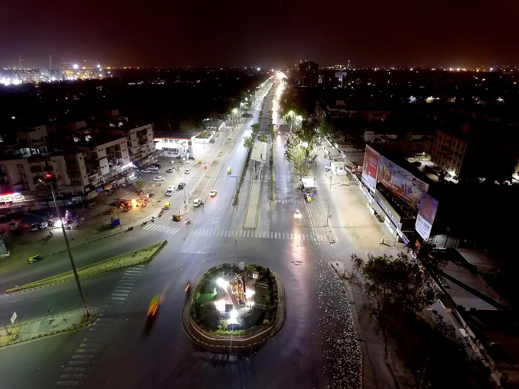 Aerial view of a junction on the BRTS corridor in Ahmedabad at night, with street lights along the roads