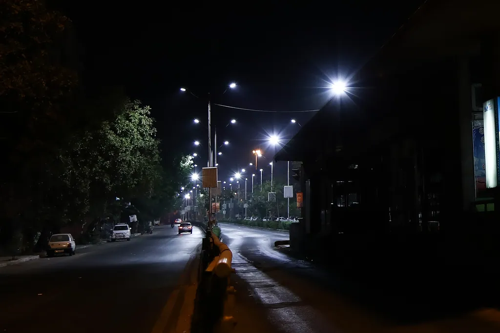 A BRTS station beside a lit street at night