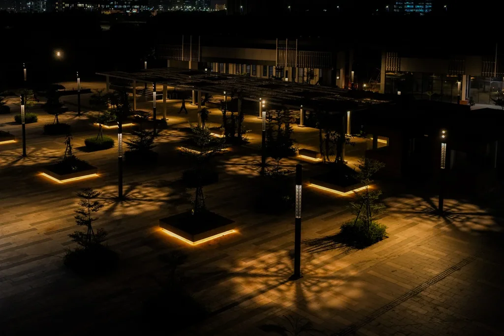 Luméa poles and lit planters across the Central Park plaza at night