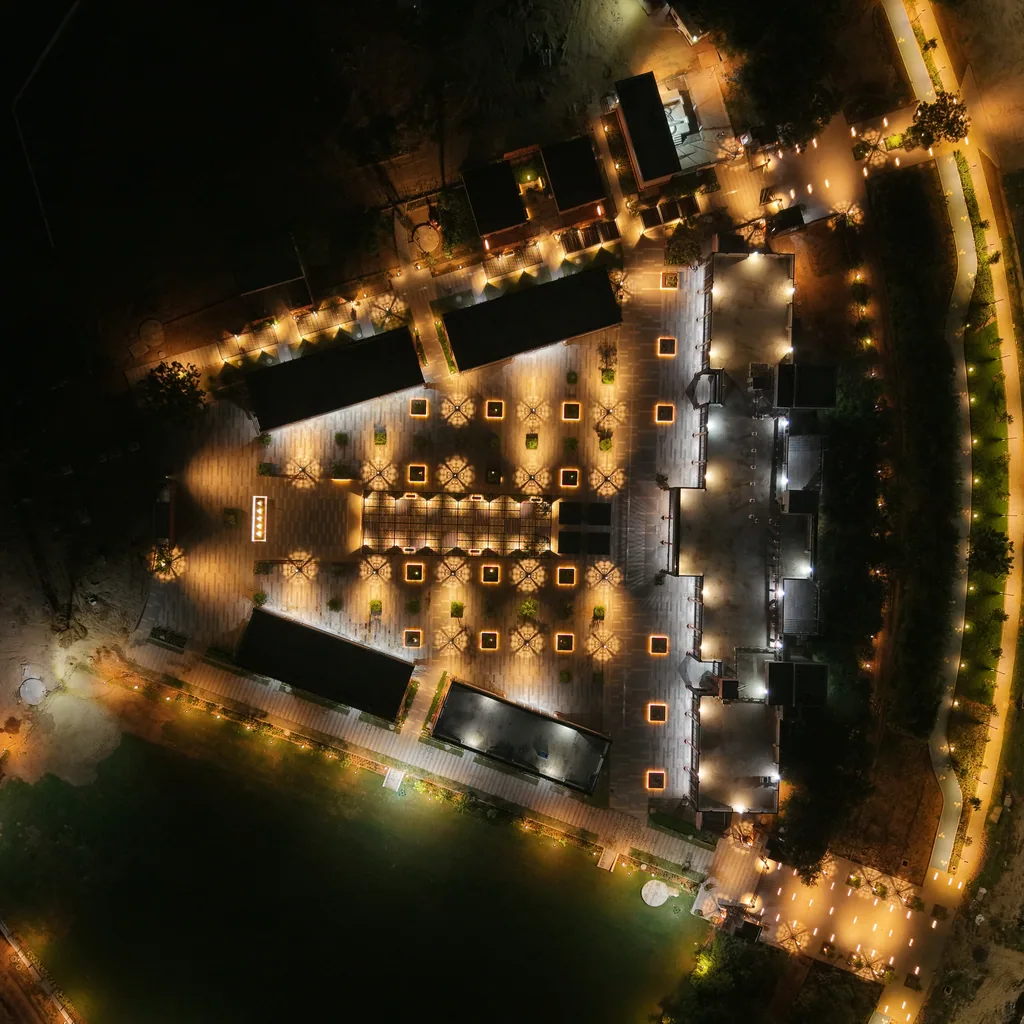 The Central Park plaza seen from directly above at night, a grid of patterned light and lit planters