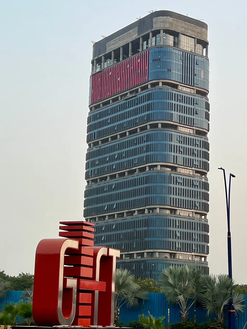 The IFSCA Building by day during construction, behind the GIFT sign