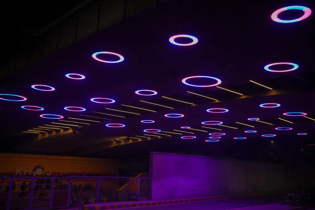 Rings of several sizes and lines of warm light on the underside of Nehru Bridge