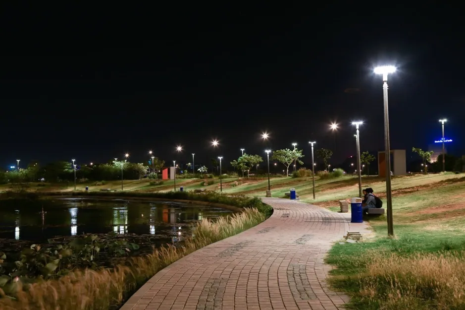 Post tops beside a curving brick path and a pond in the Flower Garden on the Sabarmati Riverfront