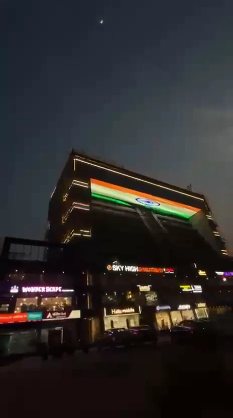 An oblique view of The ICONIC at dusk with its pixel mesh band lit