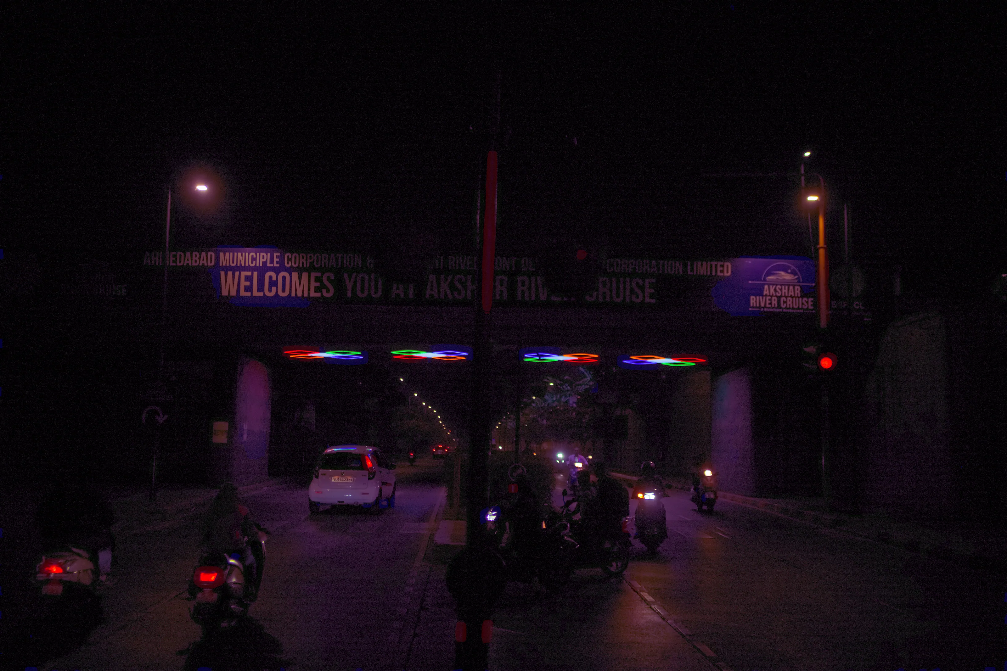 Traffic approaching the underbridge at night.