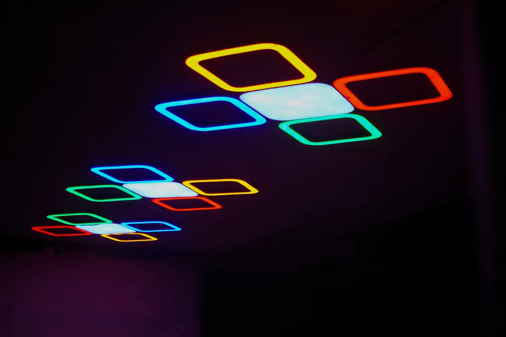 Close view of a cluster light: a white centre panel framed by yellow, red, green and blue outlines