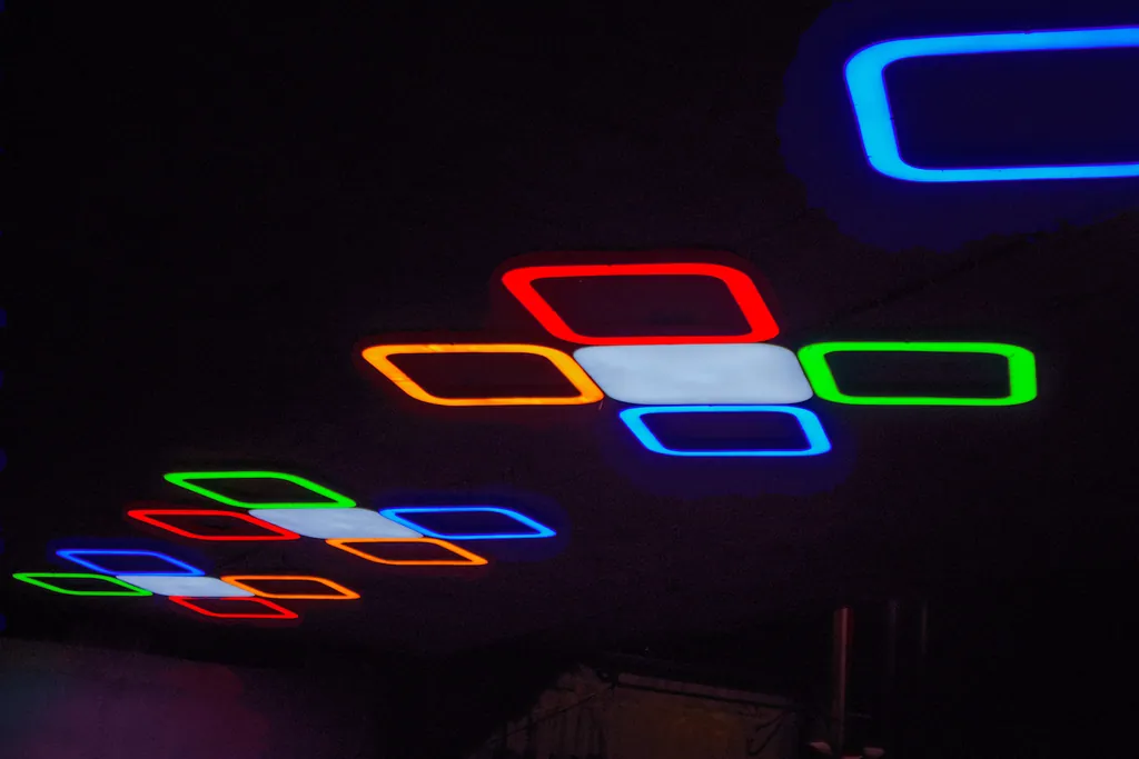 Looking up at a cluster light with red, orange, green and blue frames